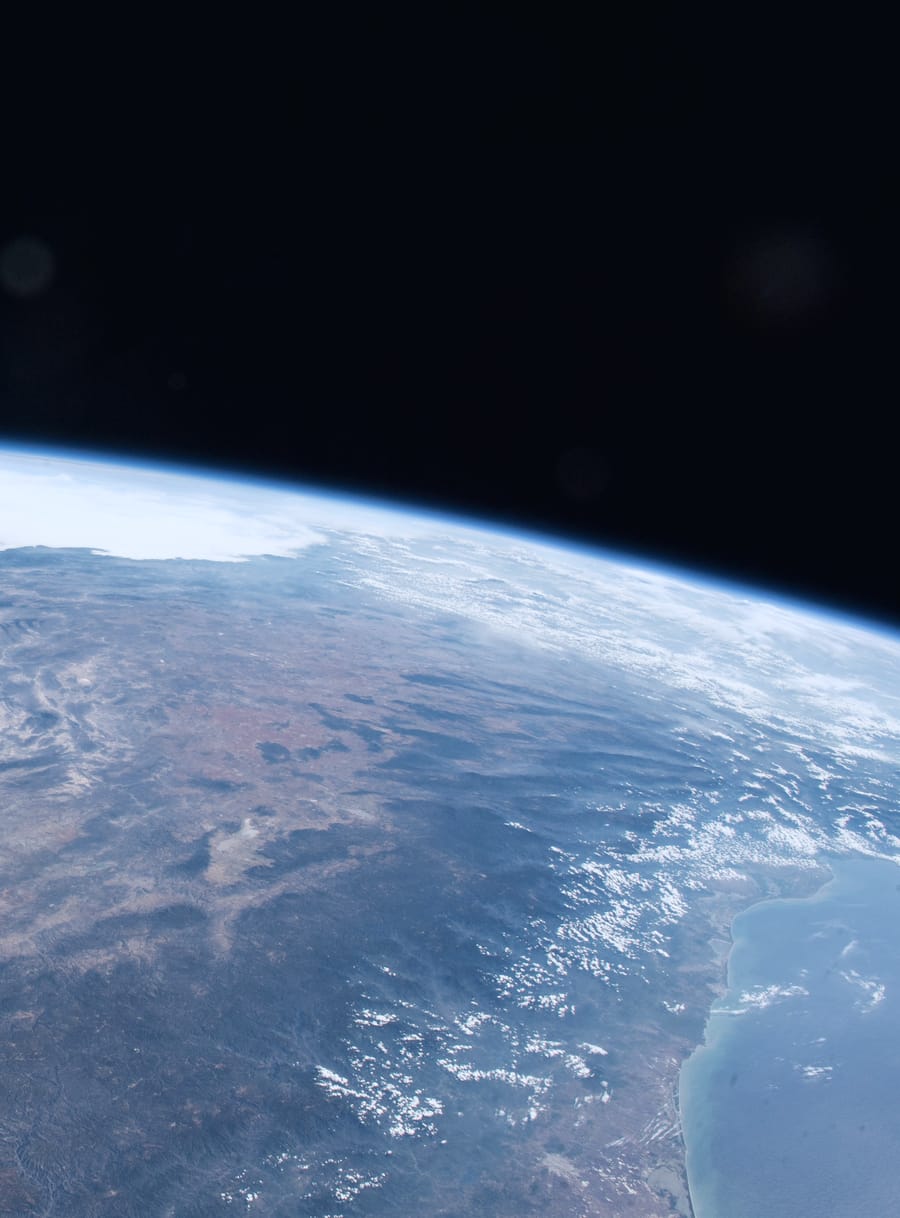 The Sonoran Desert and the Gulf of California photographed from the International Space Station: the curve of the Earth below, the thin blue line of the atmosphere, and the black of space above it.